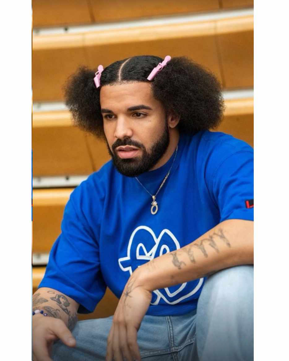Rapper Drake wears pink hairclips in his frizzed-out hair