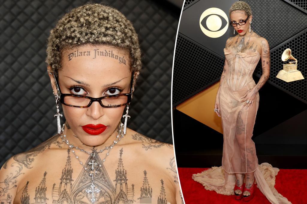 Doja Cat flaunts tattooed body in dress made to look like a wardrobe malfunction at Grammys 2024
